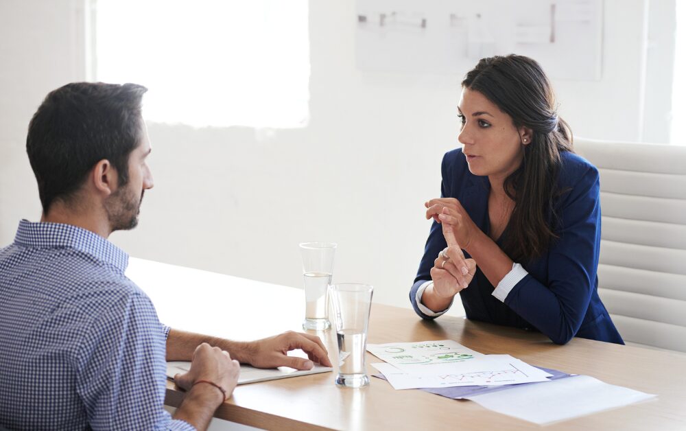 A leadership coach in in a conversation with an employee